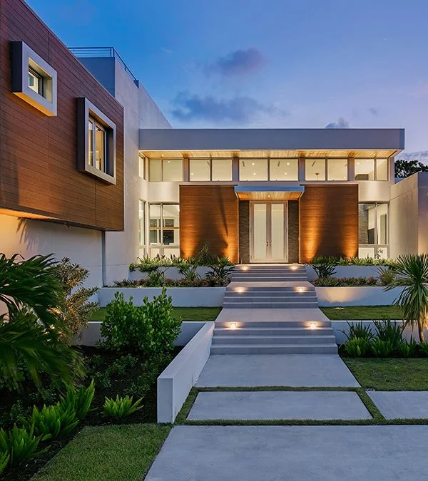 Nichiha VintageWood Cedar siding on the entry of a modern home at dusk